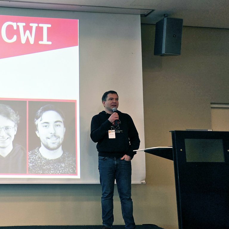 Peter Boncz presenting a paper at CIDR in front of a screen showing the CWI logo